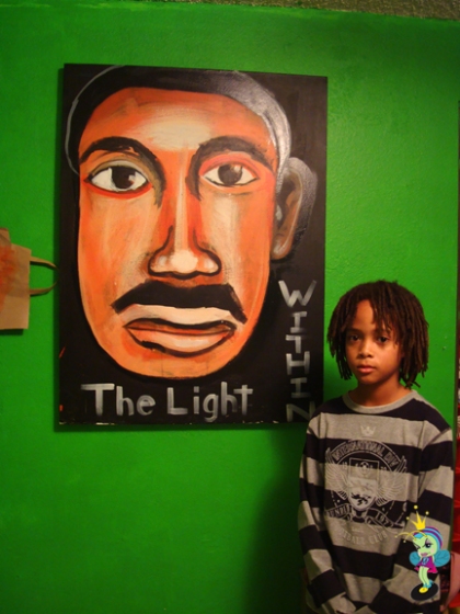 Baqi (the artist) with his painting "The Light Within"